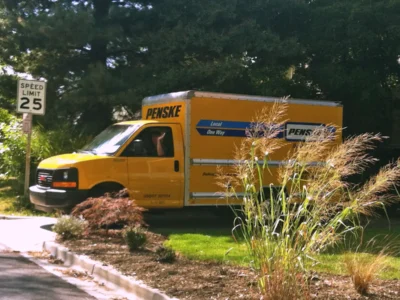 Rented truck in driveway of house.