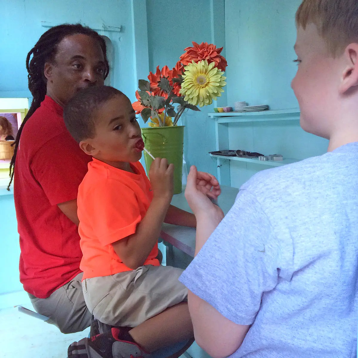 Father and son playing inside the diner playhouse.