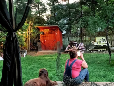 The builder and her dog sitting before the demolition.